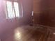 Bedroom featuring hardwood floors, baseboards and one window at 504 S 12Th St, Leesburg, FL 34748