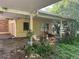 View of the carport shows the open area and garden space at 504 S 12Th St, Leesburg, FL 34748