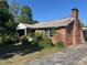 Charming brick home featuring a chimney and a well-maintained yard with mature trees at 504 S 12Th St, Leesburg, FL 34748