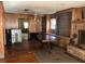 Cozy living room featuring wood paneling, fireplace, chandelier, and spacious design at 504 S 12Th St, Leesburg, FL 34748