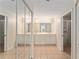 Bright bathroom featuring double sinks, a mirrored closet door, and a glass enclosed shower at 5340 Edgewater Way # 1, Oxford, FL 34484