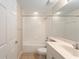 Bathroom features tub shower combination, white tiled walls, and single sink vanity at 5340 Edgewater Way # 1, Oxford, FL 34484