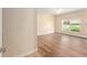 Bright bedroom with hardwood floors and large window overlooking yard at 5340 Edgewater Way # 1, Oxford, FL 34484