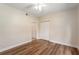 Bright bedroom featuring wood-look flooring, neutral walls, and a double door closet at 5340 Edgewater Way # 1, Oxford, FL 34484