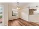 Bright dining area features hardwood floors and modern lighting fixture at 5340 Edgewater Way # 1, Oxford, FL 34484
