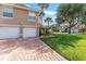 Charming townhome featuring a two-car garage, brick driveway, and verdant lawn that offers great curb appeal at 5340 Edgewater Way # 1, Oxford, FL 34484