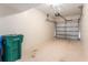 Spacious garage with white walls, speckled floors, and a roll-up door offers ample parking at 5340 Edgewater Way # 1, Oxford, FL 34484