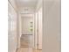 Hallway leading to a bedroom with wood-look floors and view to outdoors at 5340 Edgewater Way # 1, Oxford, FL 34484