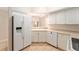 Kitchen features white cabinets, appliances, and a view to the living area at 5340 Edgewater Way # 1, Oxford, FL 34484