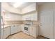 Bright kitchen features white appliances and ample counter space at 5340 Edgewater Way # 1, Oxford, FL 34484