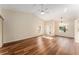 Open living room with hardwood floors, vaulted ceiling, and a ceiling fan for energy efficiency and comfort at 5340 Edgewater Way # 1, Oxford, FL 34484