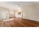 Open-concept living room featuring hardwood floors, a breakfast bar, and an inviting atmosphere for entertaining guests at 5340 Edgewater Way # 1, Oxford, FL 34484