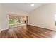 Bright living room with hardwood floors, vaulted ceilings, and sliding glass doors that lead to a screened patio at 5340 Edgewater Way # 1, Oxford, FL 34484