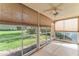 Enclosed patio with tile floors, windows, and a ceiling fan provide a comfortable outdoor living space at 5340 Edgewater Way # 1, Oxford, FL 34484