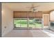Relaxing screened patio offers a ceiling fan, large windows and outdoor view of a lush lawn at 5340 Edgewater Way # 1, Oxford, FL 34484