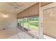 Clean screened patio features glass doors, a ceiling fan, and outdoor views with lots of natural light at 5340 Edgewater Way # 1, Oxford, FL 34484