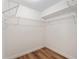 Walk-in closet featuring white wire shelves and wood-look flooring at 5340 Edgewater Way # 1, Oxford, FL 34484