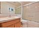 Bathroom showcasing a vanity with a sink, toilet, and a shower with sliding glass doors at 631 San Pedro Dr, The Villages, FL 32159