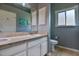 Bathroom with double sinks, granite countertops, and a frosted window for privacy at 631 San Pedro Dr, The Villages, FL 32159
