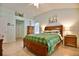 Bedroom featuring a wooden bedframe, dresser, and access to an ensuite bathroom at 631 San Pedro Dr, The Villages, FL 32159