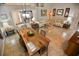 Open dining area featuring a modern light fixture and views into the kitchen and living room at 631 San Pedro Dr, The Villages, FL 32159
