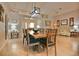 Open-concept dining room with a large table, chandelier, and seamless access to the living area at 631 San Pedro Dr, The Villages, FL 32159