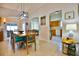 Open dining area featuring a modern light fixture and views into the kitchen and living room at 631 San Pedro Dr, The Villages, FL 32159