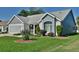 Charming home featuring neutral siding, brick accents, well-maintained landscaping, and an attached two-car garage at 631 San Pedro Dr, The Villages, FL 32159
