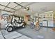 Spacious garage featuring golf cart, bicycles, storage, and laundry area for convenience at 631 San Pedro Dr, The Villages, FL 32159