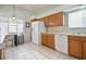 Well-lit kitchen with white appliances, wood cabinetry, and window overlooking the backyard at 631 San Pedro Dr, The Villages, FL 32159