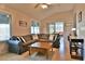 Inviting living room with vaulted ceiling, large sectional sofa, and sliding doors leading to the outdoors at 631 San Pedro Dr, The Villages, FL 32159