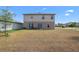 Large backyard with patio, sliding glass door, and ample space for outdoor activities at 6401 Domenico Ct, Groveland, FL 34736