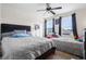 Bright bedroom with two beds, ceiling fan and natural light streaming through the windows at 6401 Domenico Ct, Groveland, FL 34736