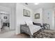 Cozy bedroom with a bed, carpet, and decorative mirror at 6401 Domenico Ct, Groveland, FL 34736