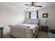 Comfortable bedroom featuring a bed, nightstand with lamp, and ceiling fan at 6401 Domenico Ct, Groveland, FL 34736
