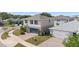 Two-story home with blue shutters, a two-car garage and brick paved driveway at 6401 Domenico Ct, Groveland, FL 34736