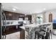 Well-equipped kitchen with a breakfast bar, modern appliances, and dark wood cabinetry at 6401 Domenico Ct, Groveland, FL 34736
