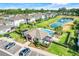 Aerial view of community clubhouse, pool, and green space in a residential area, with a lake and fountain feature at 644 Orange Belt Loop, Winter Garden, FL 34787
