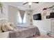 Comfortable bedroom has a TV, bedside table, and a neutral color scheme, creating a calm atmosphere at 644 Orange Belt Loop, Winter Garden, FL 34787