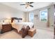 Comfortable bedroom featuring a ceiling fan, two windows, neutral walls, and a carpeted floor at 644 Orange Belt Loop, Winter Garden, FL 34787