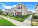 Well-kept townhome with a lush lawn, complemented by colorful shutters and a neat landscape at 644 Orange Belt Loop, Winter Garden, FL 34787