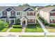 Beautiful townhome with well-maintained landscaping, red shutters, and a cozy front porch at 644 Orange Belt Loop, Winter Garden, FL 34787