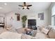 Inviting living room with a ceiling fan and cozy seating near shelves at 644 Orange Belt Loop, Winter Garden, FL 34787