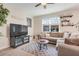 Comfortable living room features neutral-toned sofas, a coffee table, a ceiling fan and shelving at 644 Orange Belt Loop, Winter Garden, FL 34787