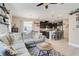 Open-concept space with a living room, dining area, and kitchen with dark cabinets and an island at 644 Orange Belt Loop, Winter Garden, FL 34787