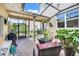 Relaxing screened patio with comfortable seating, perfect for outdoor entertaining and grilling at 644 Orange Belt Loop, Winter Garden, FL 34787