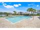 Community pool with lounge chairs, palm trees, and a clear blue sky, perfect for relaxation at 644 Orange Belt Loop, Winter Garden, FL 34787