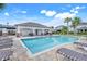 Community pool featuring a shaded pergola, tables and chairs for socializing and enjoying poolside leisure at 644 Orange Belt Loop, Winter Garden, FL 34787