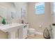 This powder room has a pedestal sink, wood floors, and a decorative mirror at 644 Orange Belt Loop, Winter Garden, FL 34787