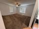 Large bedroom featuring carpeted floors, ceiling fan, and large windows at 677 Warner St, Groveland, FL 34736